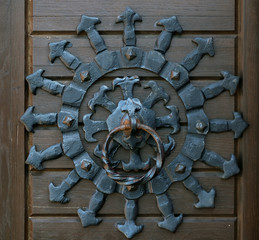Iron knocker of old door.