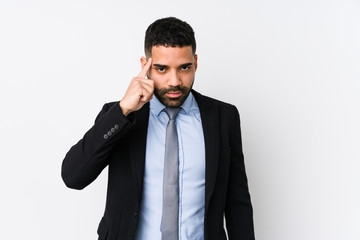 Young latin business woman against a white background isolated pointing temple with finger, thinking, focused on a task.