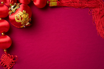 Chinese New Year decorations with red background with assorted festival decorations. Chinese characters means abundant of wealth, prosperity and luck. Flat lay.