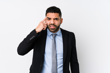 Young latin business woman against a white background isolated showing a disappointment gesture with forefinger.