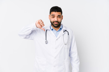 Fototapeta premium Young arabian doctor man isolated showing a dislike gesture, thumbs down. Disagreement concept.