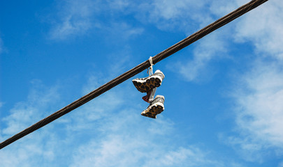 shoes hanging on an electric wire