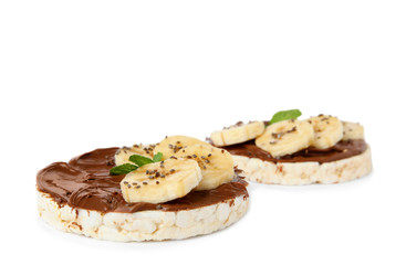 Puffed rice cakes with chocolate spread, banana and mint isolated on white