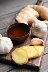 Fototapeta na wymiar Fresh garlic and other natural cold remedies on light grey wooden table