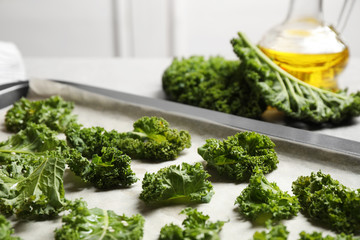 Fototapeta premium Raw cabbage leaves on baking sheet, closeup. Preparing kale chips