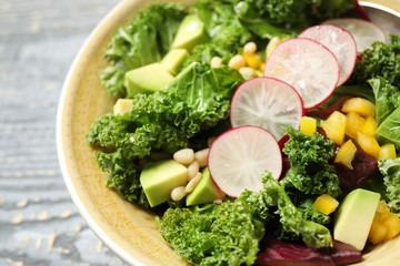 Delicious fresh kale salad in bowl, closeup