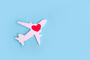 Happy Valentines day. Children's plane on a blue background with red heart