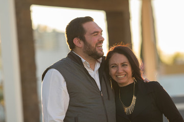 Portrait of young man couple with beard and young woman smiling and enjoying the company posing for the camera. Laughing.