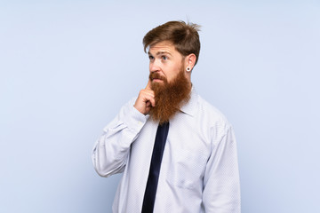 Businessman with long beard over isolated background thinking an idea