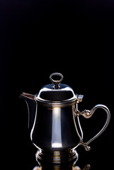  Kettle brilliant with tea on black background