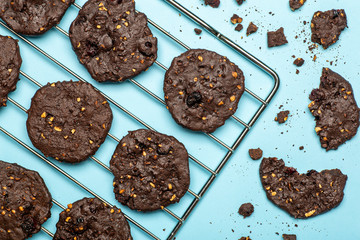 Homemade gluten-free chocolate chip cookies with cereals, nuts and organic cocoa. Cookies and pastries from rye flour on a colored background. Gluten free concept