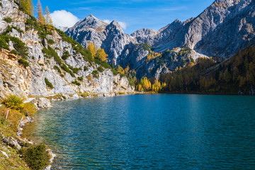 Obraz premium Sunny autumn alpine Tappenkarsee lake and rocky mountains above, Kleinarl, Land Salzburg, Austria.