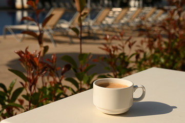 cup of coffee in a poolside restaurant, food and leisure concept