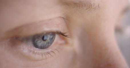 Reflection of smartphone in woman&rsquo;s blue eye