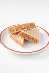 Fresh home made waffle cake with condensed milk. On a white background.