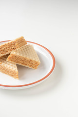 Fresh home made waffle cake with condensed milk. On a white background.