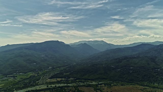 Drone, aerial view of mountain range in Greece with cumulus, stratus and cirrus clouds. Mountain panorama.