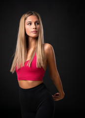 Fototapeta premium Young sport blonde woman over isolated black background