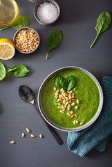 green creamy cauliflower spinach soup on gray background