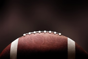 American football ball on dark background