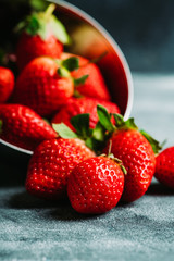 Ripe and juicy strawberries on the dark rustic background. Selective focus. Shallow depth of field.