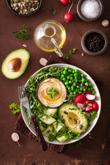 healthy vegan lunch bowl with avocaco cucumber hummus peas radish