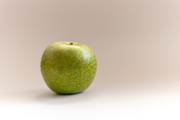 Close up of a granny green apple in grey background