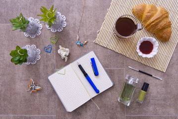 Fototapeta na wymiar croissant on a table with a notebook