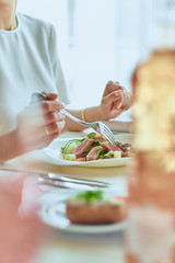woman eating salad in restaurant