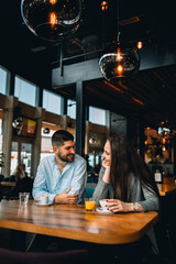 happy couple drinking coffee in cafe bar
