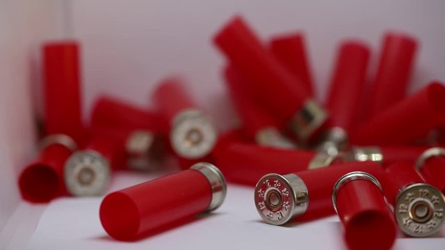 Red shotgun shell on a white background. 12 gauge. concept of hunting, defense or war. self defense