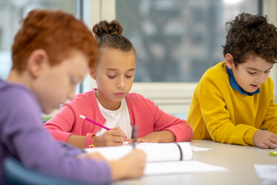 Focused School Children Working On Their Exercises