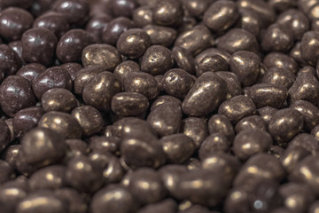 Background of candy nuts in chocolate. Selective focus.