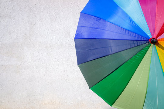 Colorful umbrella isolated on a white background wall a sunny day.