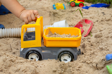 Fototapeta na wymiar Toy truck in the sandbox