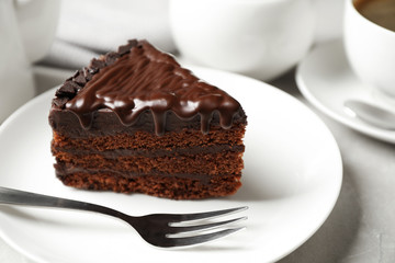 Tasty chocolate cake served on white table, closeup