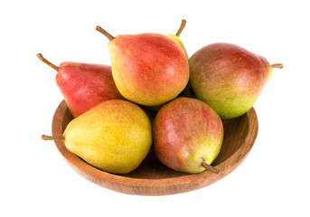 Fresh pears on the wooden plate. On white background