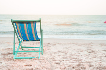 beach chair at side of beach with sunset background on autumn season