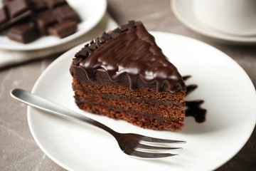 Tasty chocolate cake served on grey table, closeup