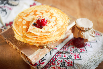Homemade hot pancakes with jam. Rustic style, crepes closeup.