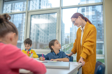 Fototapeta premium Teacher checking results of her pupils works
