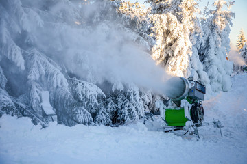 Snow-gun spraying artificial ice crystals in winter day in mountain, Liberec, Czech Republic