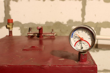 Thermometer on wood central heating system's top. Modern boiler for heating of residential house....