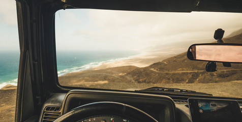 Inside view of car with mobile modern phone gps system to find the road and use maps in off road...