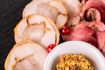 Roll of chicken with seasonings, served with sauce