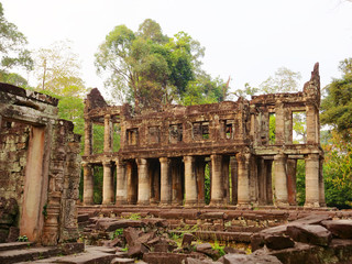 Fototapeta premium Landscape view of demolished stone architecture at Preah Khan temple Angkor Wat complex, Siem Reap Cambodia. A popular tourist attraction nestled among rainforest.