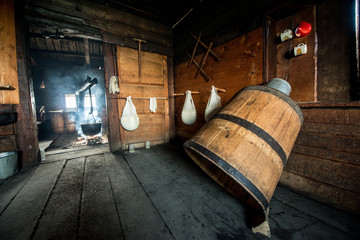 Making fresh homemade cottage cheese in cheesecloth in a wooden house