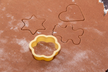 Cutting figures from the dough using special stencils for making ginger Christmas cookies. Home,...