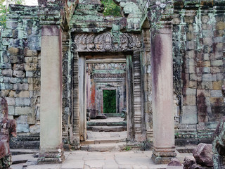 Demolished stone rock door frame at Preah Khan temple Angkor Wat complex, Siem Reap Cambodia. A popular tourist attraction nestled among rainforest.