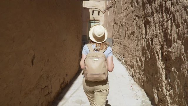 Young Woman Visiting Abandoned Old Ruined Village of Al Hamra near Nizwa, Oman
